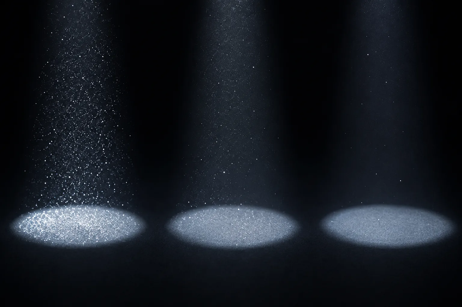 Três feixes de luz com quantidades decrescentes de partículas, ilustrando a redução do volume analisado